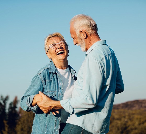 Couple smiling in hilltop outside